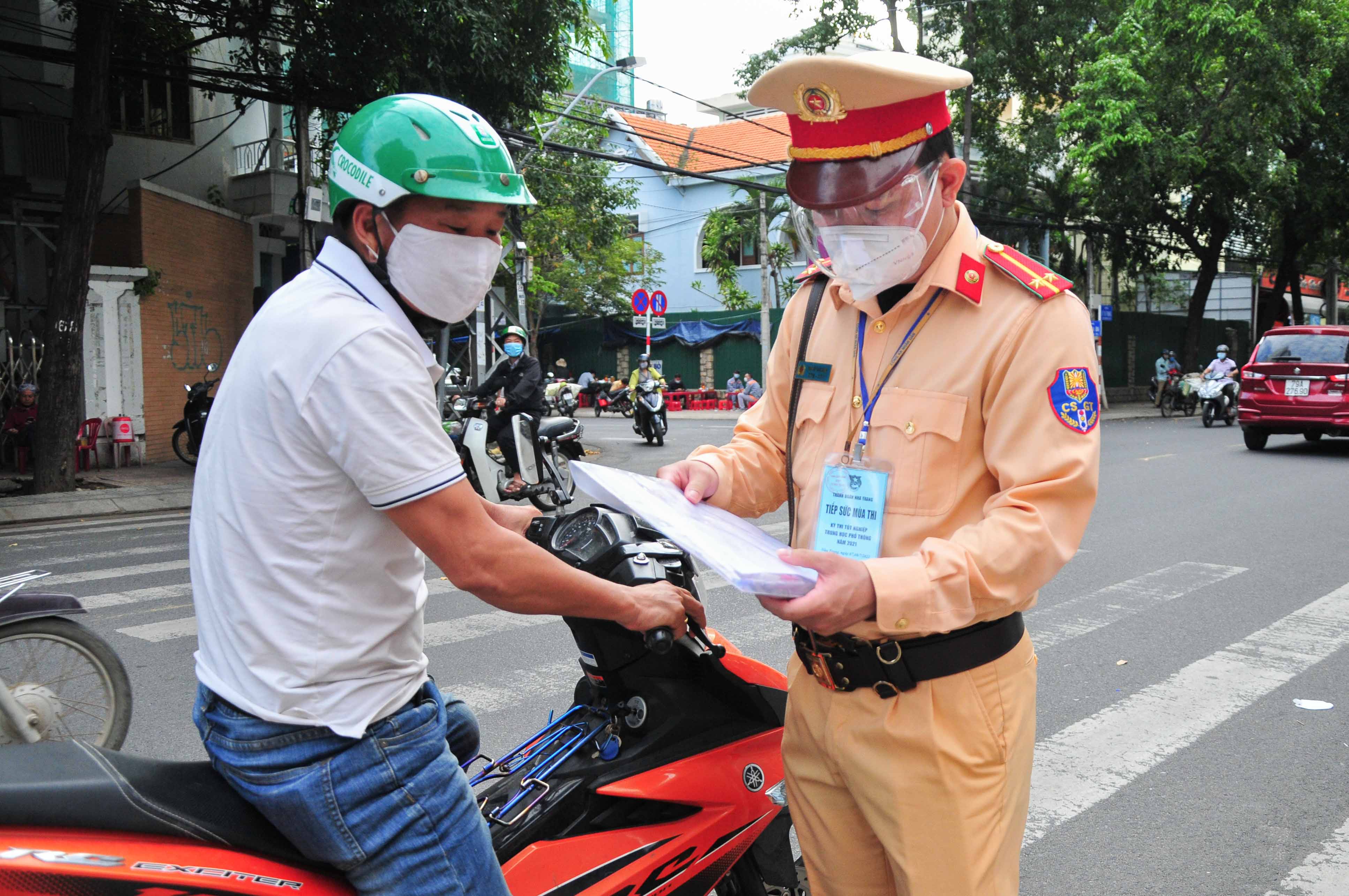 Gần đến giờ thi, một người nhà thí sinh mang giấy tờ dự thi đến nhờ lực lượng làm nhiệm vụ đưa cho thí sinh