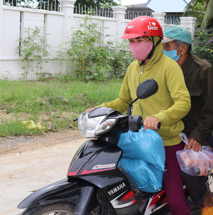 Người dân mang quà về nhà.