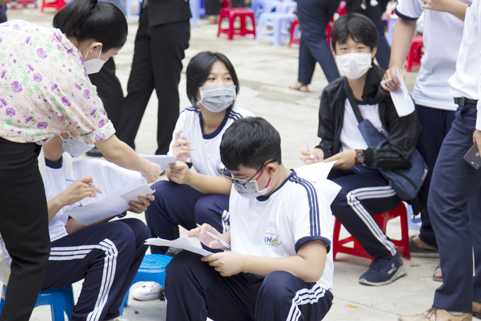 Học sinh điền thông tin để tiêm vắc xin phòng Covid-19. 