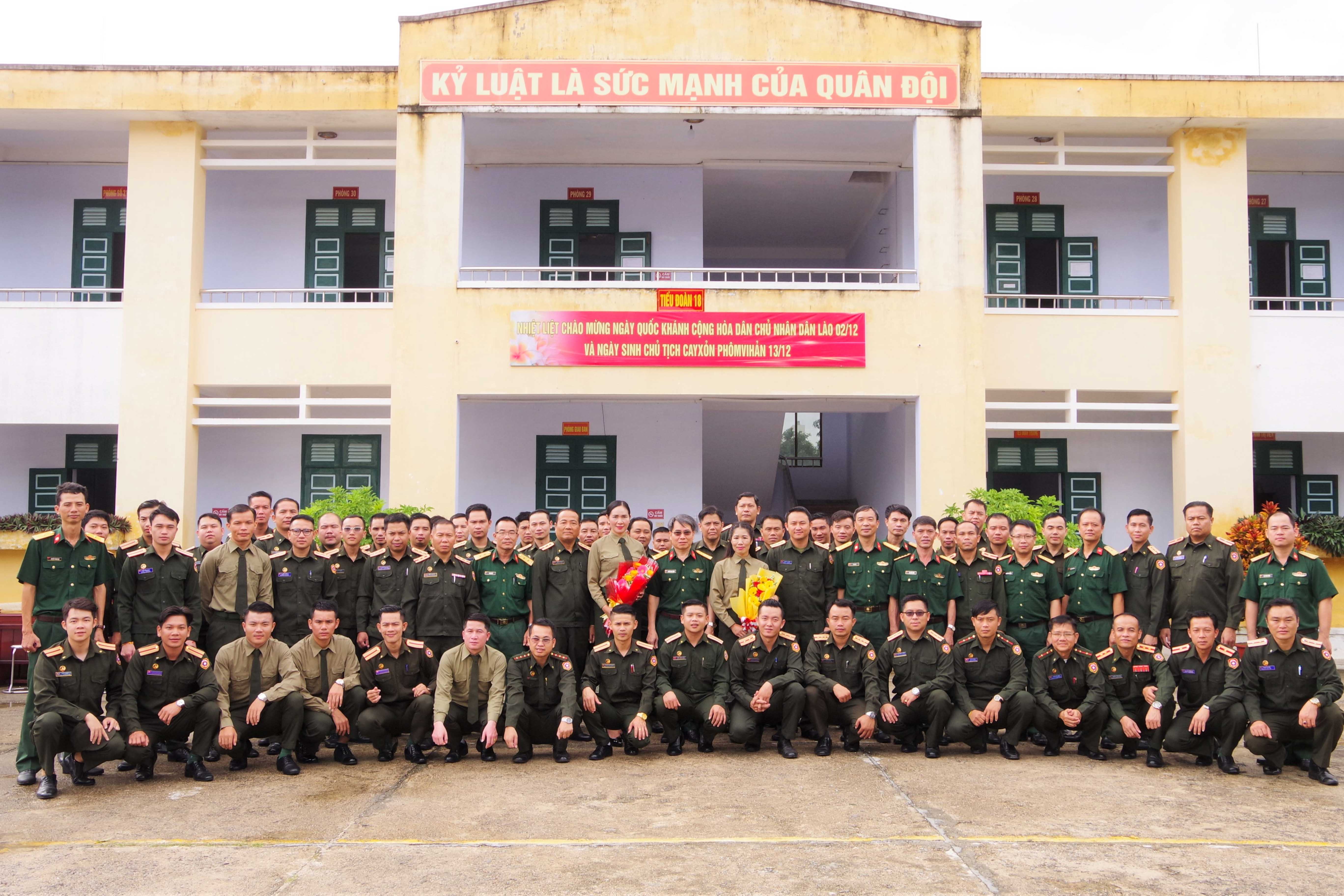 Thủ trưởng nhà trường cùng các đại biểu tặng hoa, chụp hình lưu niệm với các cán bộ, học viên Quân đội Nhân dân Lào